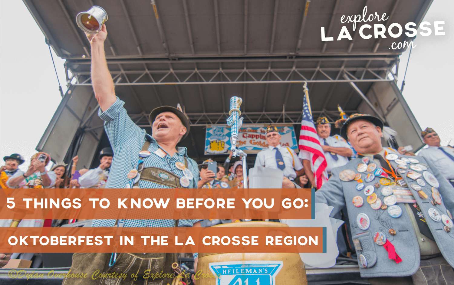 Two men raising a glass at the tapping of the golden keg on stage at Oktoberfest in La Crosse, Wisconsin